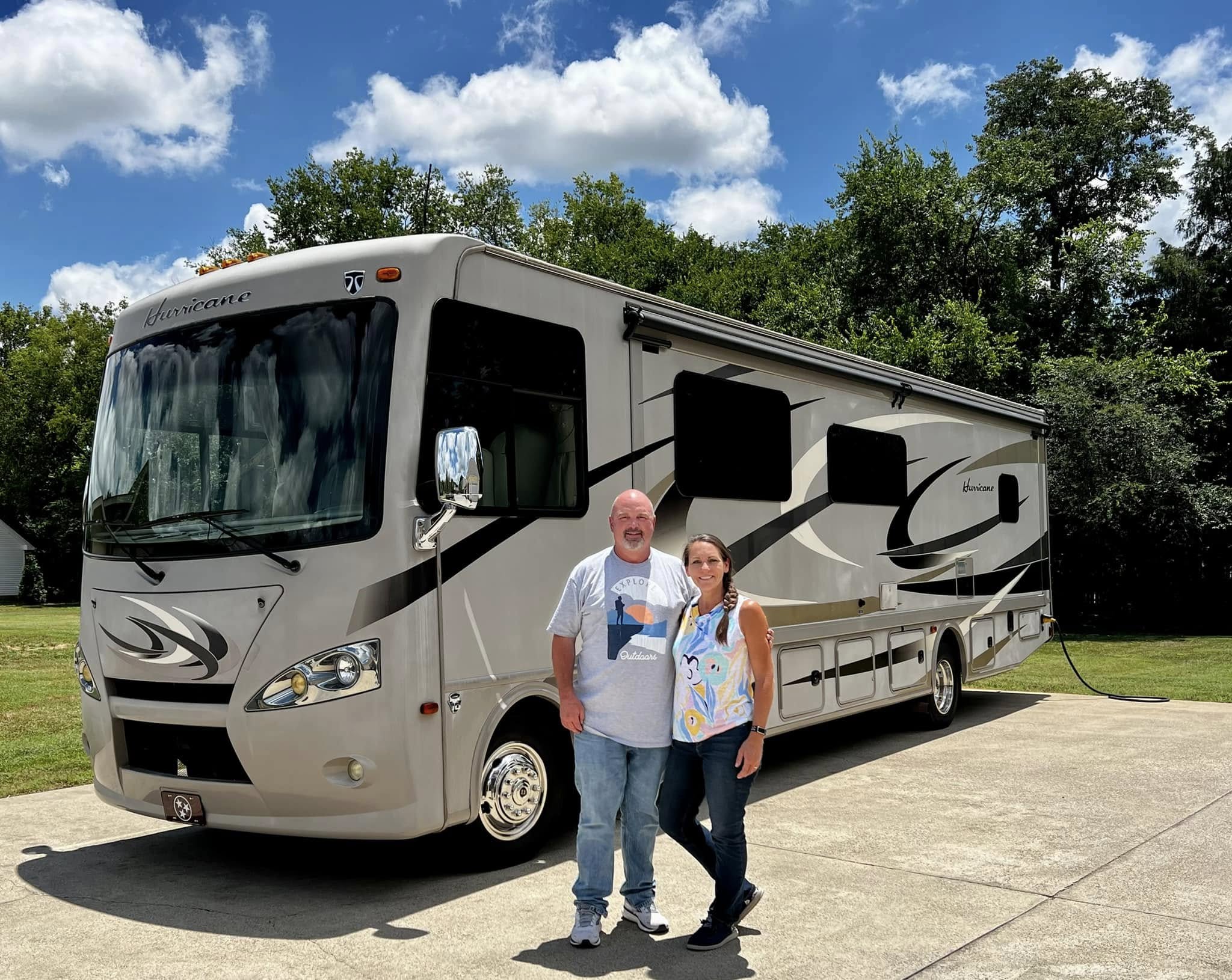 Brad and Jen in front of their Hurricane motorhome