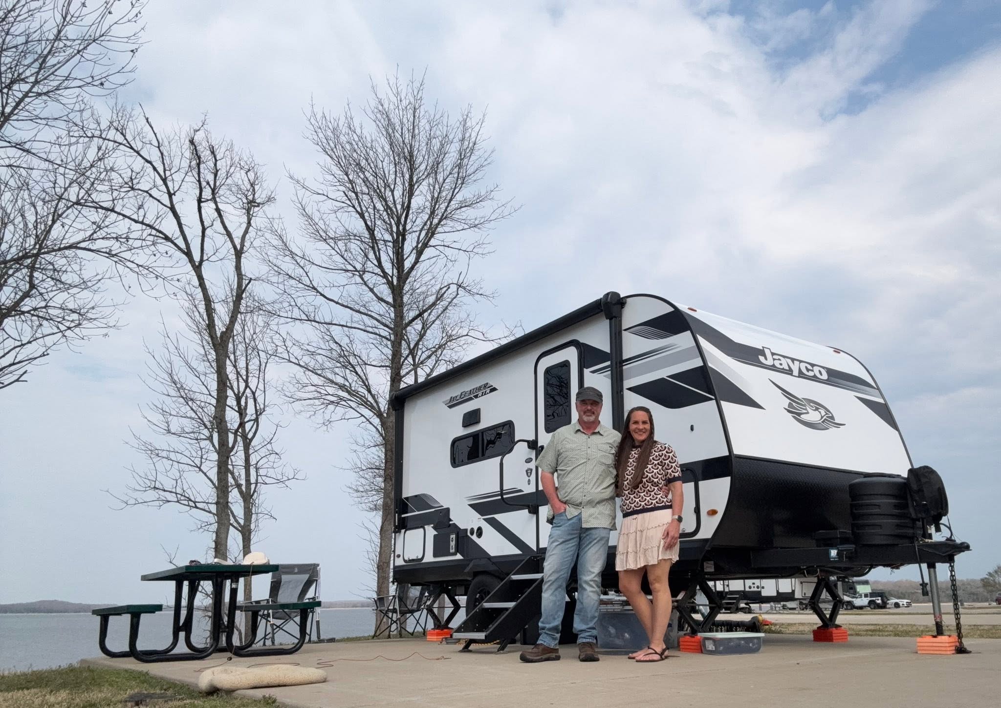 Brad and Jen with their Jayco Jay Feather beside a lake