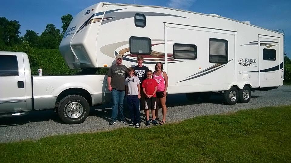 Family standing in front of Jayco Eagle fifth wheel